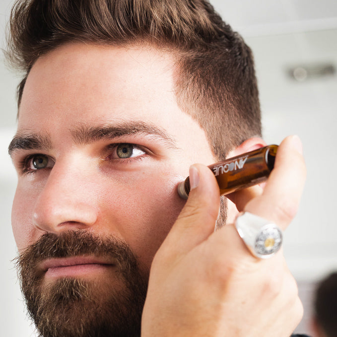 Youthful face oil being applied to face